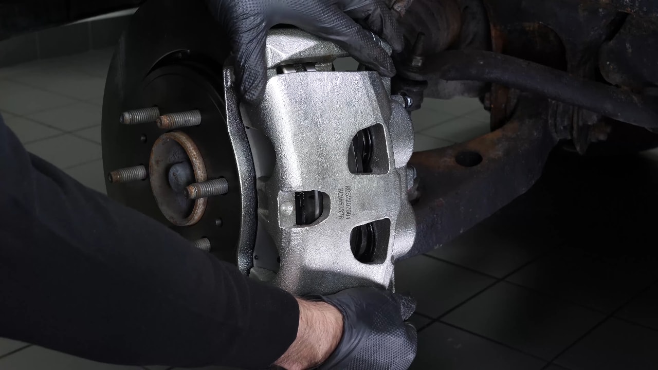 Put the brake caliper back