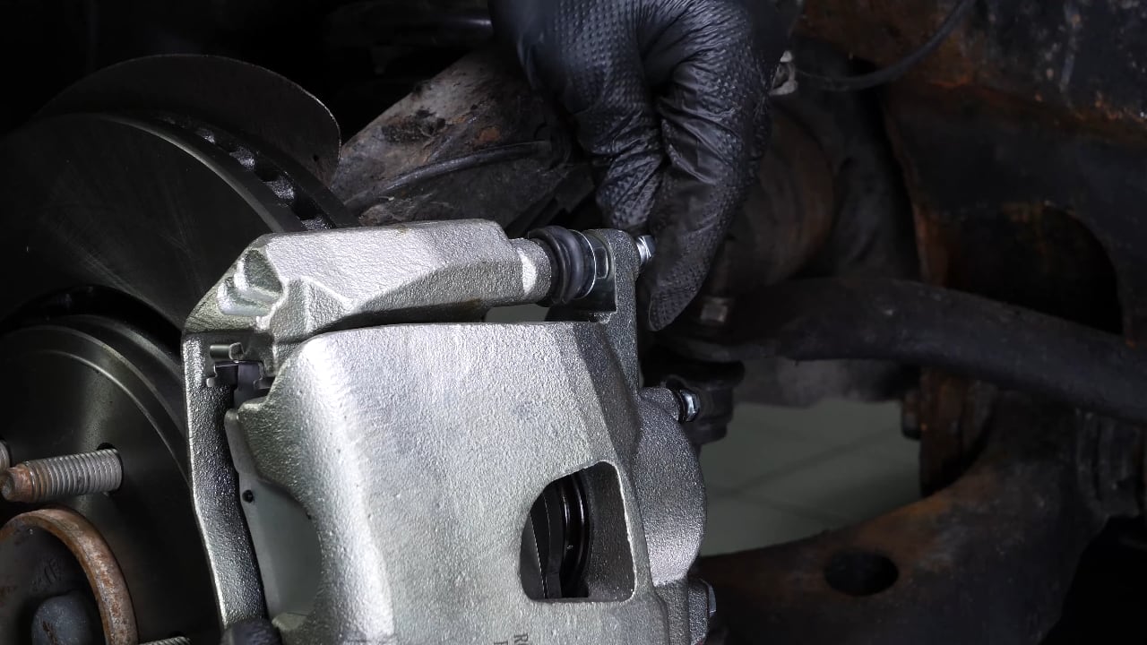 Put the brake caliper back