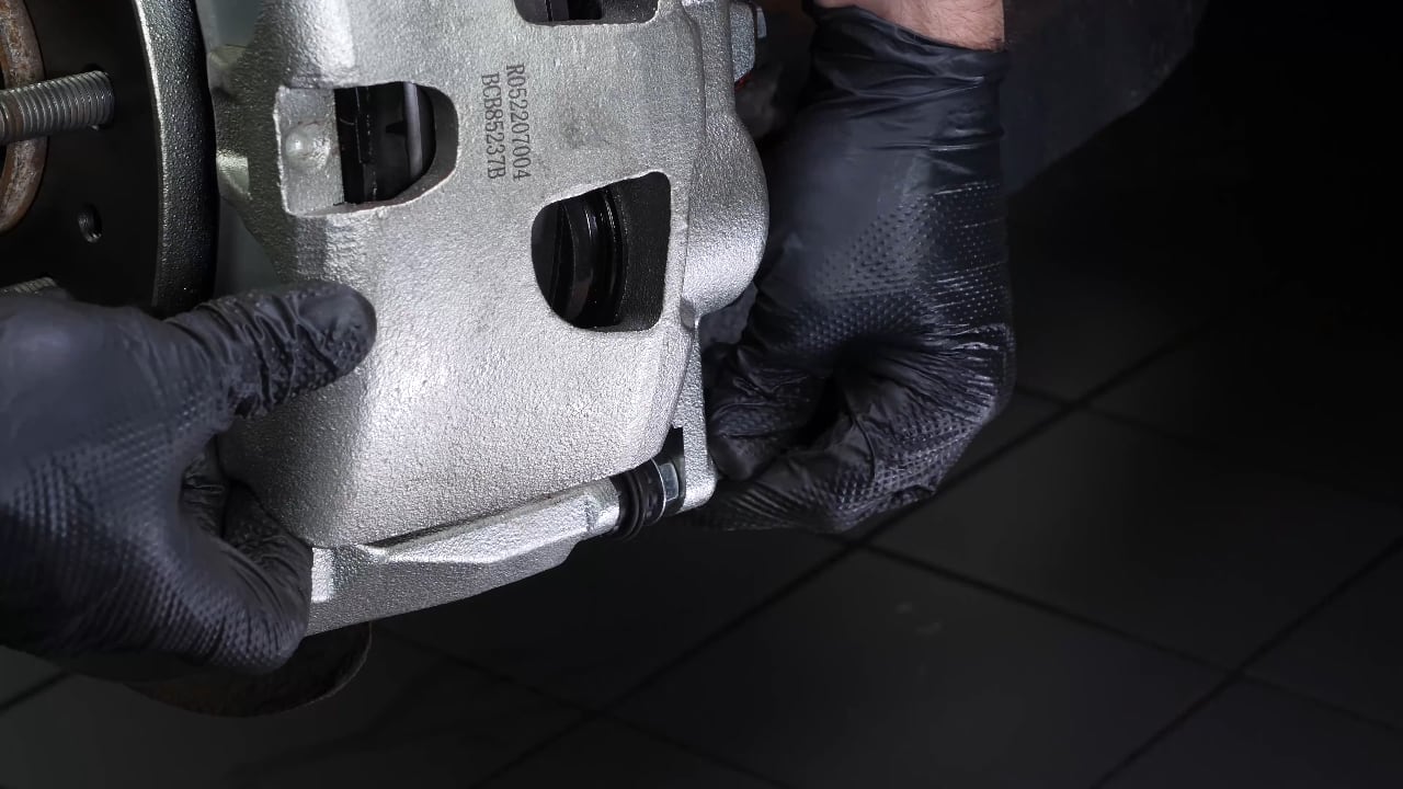 Put the brake caliper back