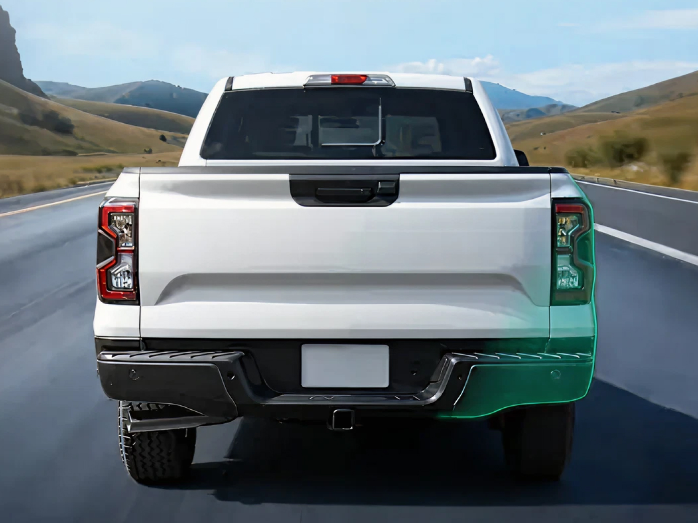 Rear view of a white pickup truck parked on a desert highway